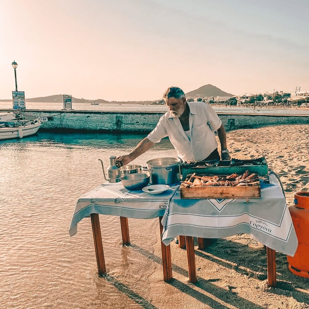 Chef Dimitris Kapris preparing fresh traditional Greek dishes by the seaside at Gorgona Taverna